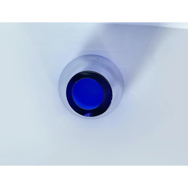 Detail of a blue vase entirely in Murano glass. Dimensions: H 53 x W 15 x D 15 cm. Origin: Italy Other variations...