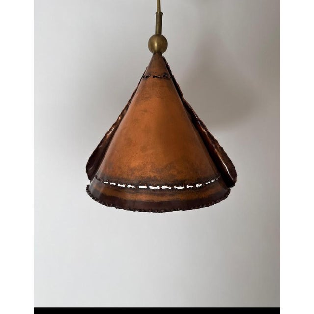 Rare set of three brutalist pendant lights. These three master-crafted copper lights are something special. The lampshade...