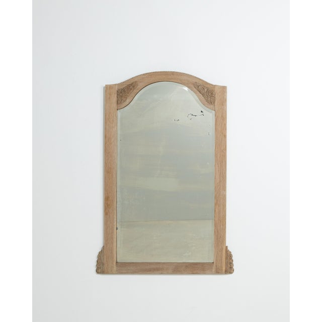A 19th century French wall mirror crafted in oak, influenced by Art Nouveau design. The frame presents subtle shaping and...