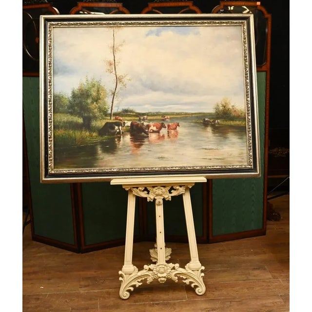 Gorgeous classic Victorian style oil painting of a pastoral river scene - Cows are shown enjoying the cool waters of the...