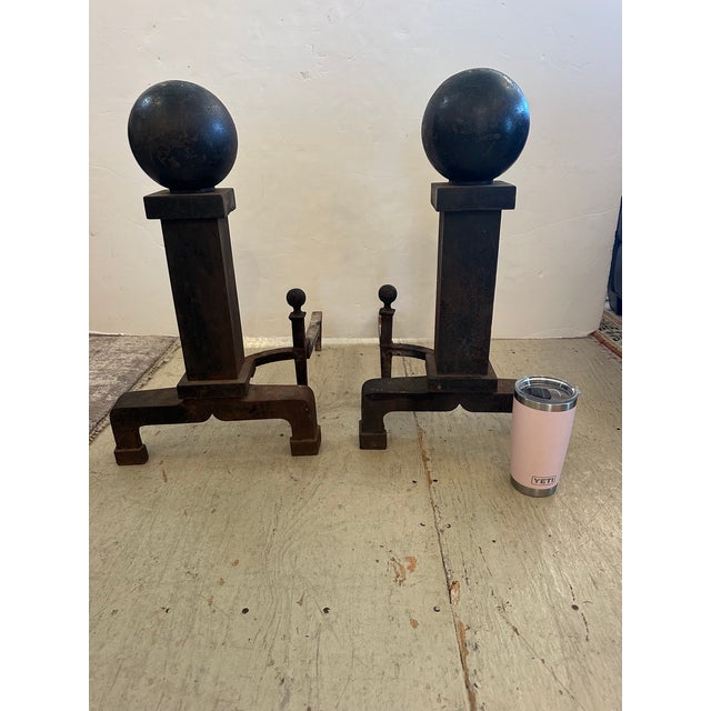 Pair of very large gutsy antique black iron cannonball andirons. Circa 1910 24” H x 14” W x 22” D
