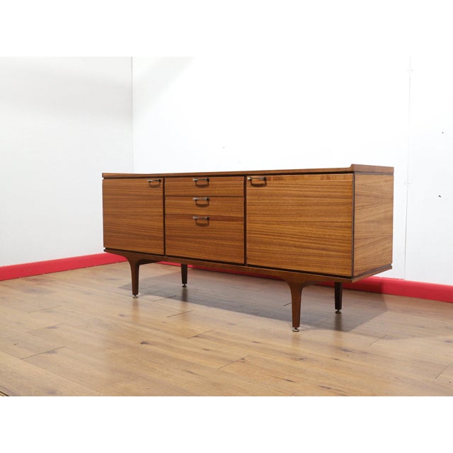 Elevate your space with this gorgeous mid century credenza by renowned furniture maker Meredew. Featuring fantastic wood...