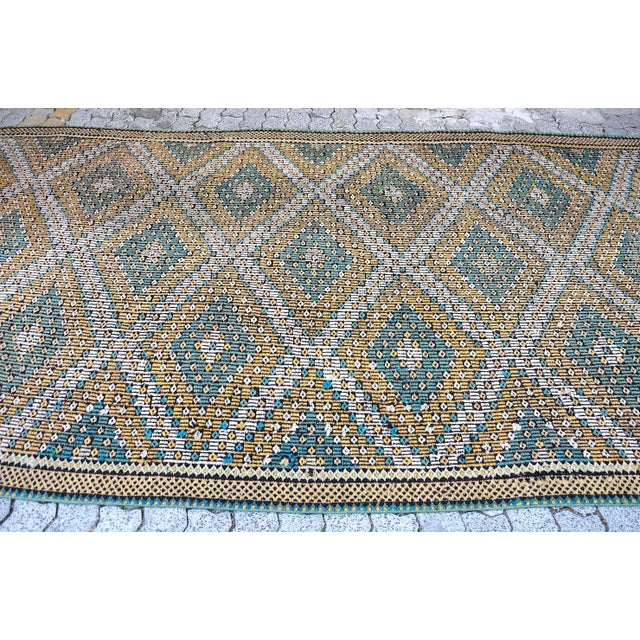 This is a vintage Turkish Anatolian kilim rug from the 1960s. The piece was hand-woven.