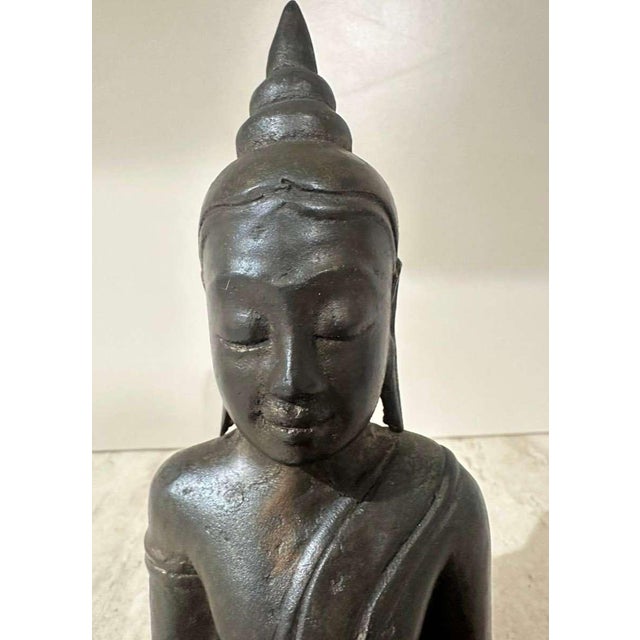 An exceptional and serene Thai bronze figure of the seated Buddha Shakyamuni, originating from the early Ayutthaya Kingdom...