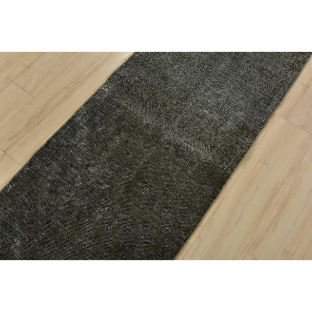 An authentic vintage traditional overdyed Tabriz runner hand-knotted with fine wool and natural dyes. This oriental rug...
