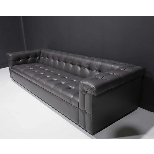 Discover the elegance of Edward Wormley's iconic party sofa for Dunbar, now reupholstered in luxurious dark gray leather....