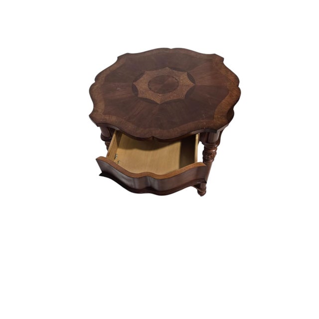 Classic traditional round accent table featuring a scalloped pie-crust top with intricate sunburst and star veneer inlay....