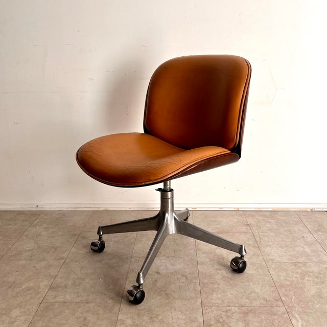 This armchair featured in this auction is part of an exclusive series of chairs with a walnut veneer shell and cast...