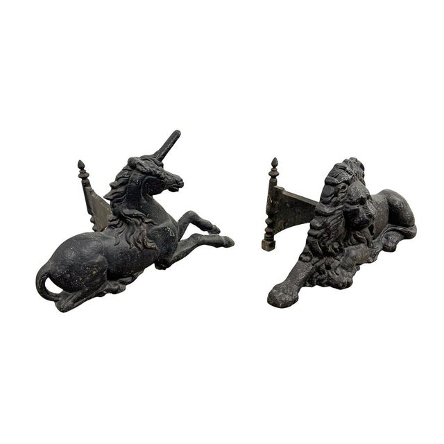 A rare and highly decorative pair of antique English cast iron boot scrapers modelled as the Lion of England and the...