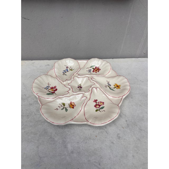 Majolica oyster plate with different flowers on each shells, circa 1900 signed Longchamp.