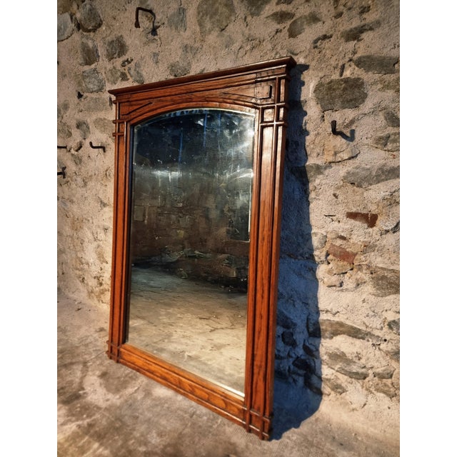 This antique French mirror dates from circa 1900–1920 and features a substantial frame crafted from solid oak. The design...