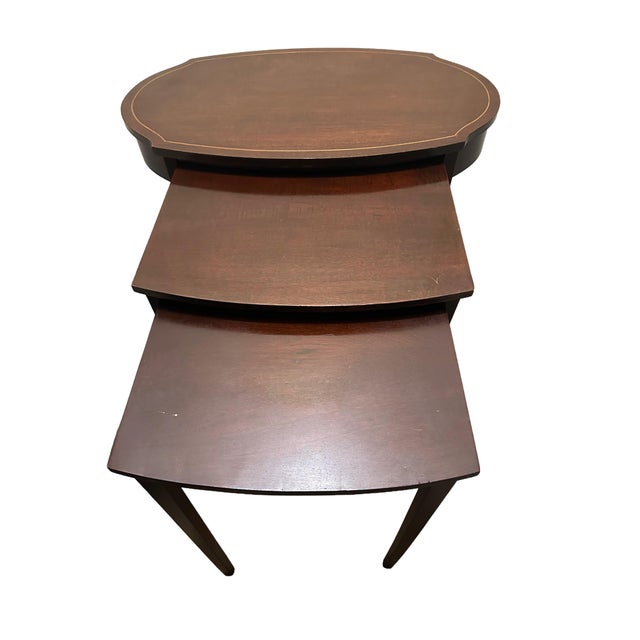 Nest of three tables in oval and rectangular form on straight-tapered legs. Middle tray is 17.5" x 15", small tray is 15"...