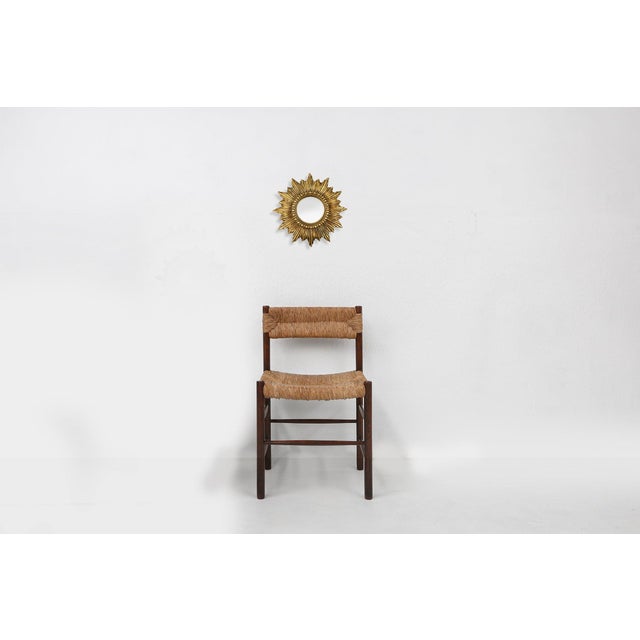 A radiant example of French mid‑century design, this 1960 sunburst mirror brings warmth, glamour, and sculptural presence...