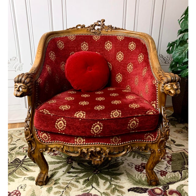 Pleased to offer a truly one-of-a-kind antique club chair fit for a king, dressed in red chenille fabric lined in studded...