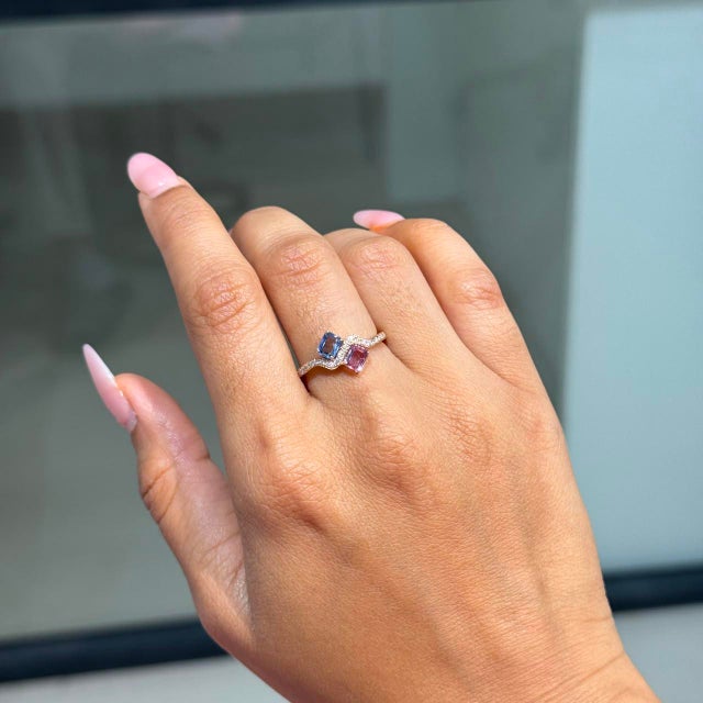 This Toi et Moi wave ring showcases 0.82 carats of natural multi sapphires, set in 14k yellow gold. Each sapphire...