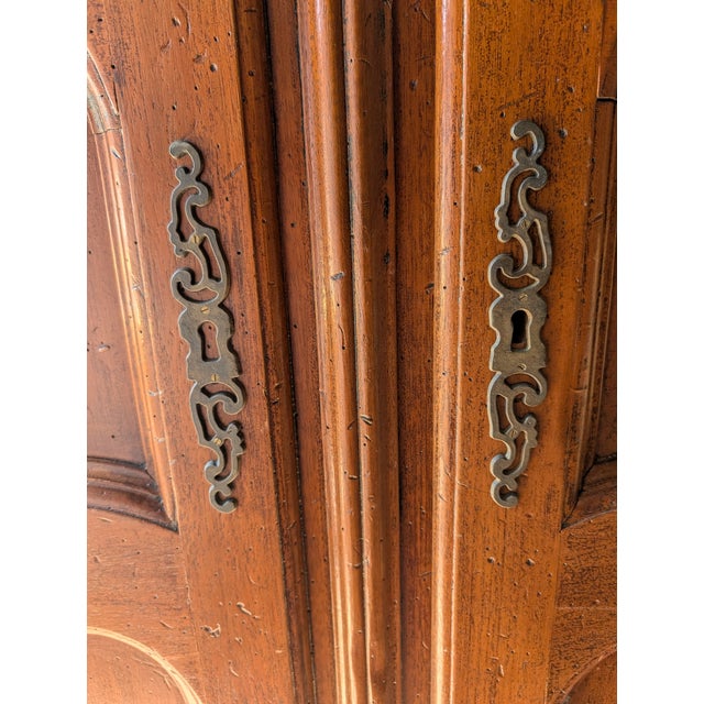 ​A magnificent example of Italian craftsmanship, this grand armoire was handmade in the Veneto region by the renowned...