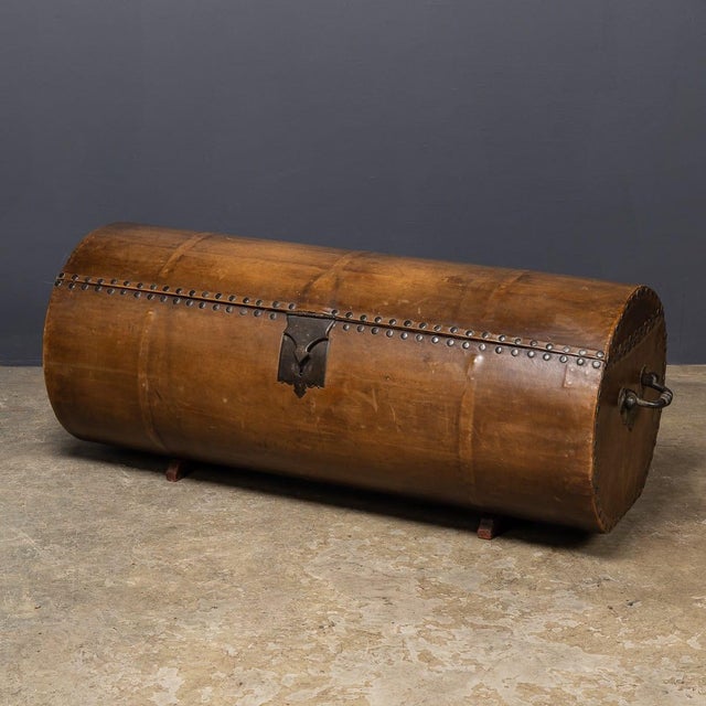 An antique 18th Century coach trunk of rare cylindrical form, fitted with brass studwork, side handles, and a central...