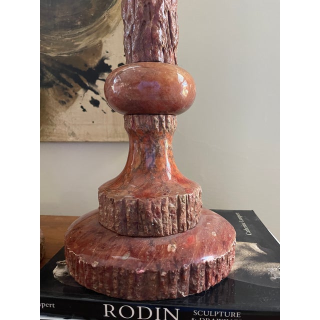 Stunning pair of marble lamps, presented in a salmon collar with variations throughout the marble, the slender lamps...