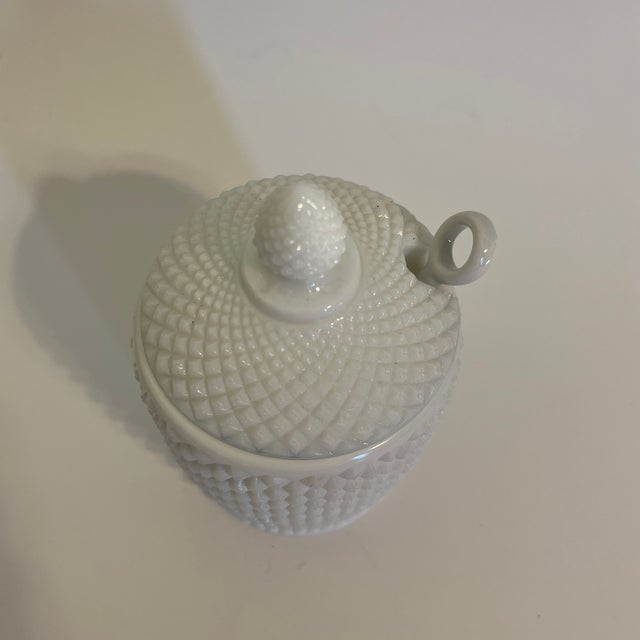 Good condition, the spoon is replaced with a porcelain spoon with a loop end. White Milk Glass with lid, Hobnail design.