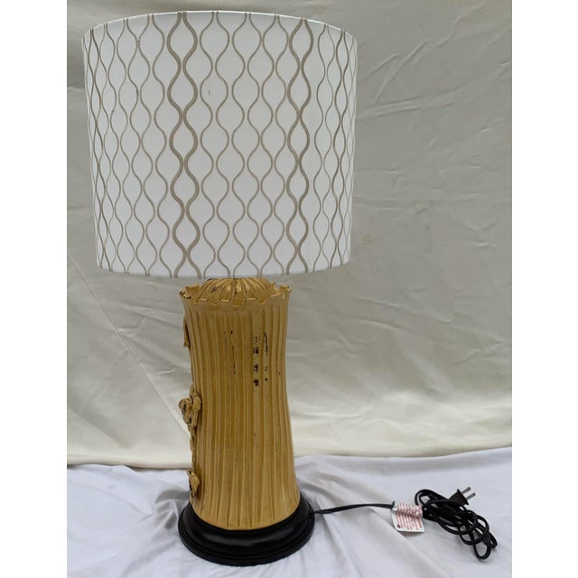 Mid-Century style painted and glazed ceramic table lamp. Grape vine relief design with bunches of grapes hanging from the...