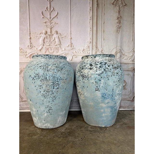 An exceptional pair of large-scale antique terracotta storage jars, distinguished by their beautifully aged surfaces and...