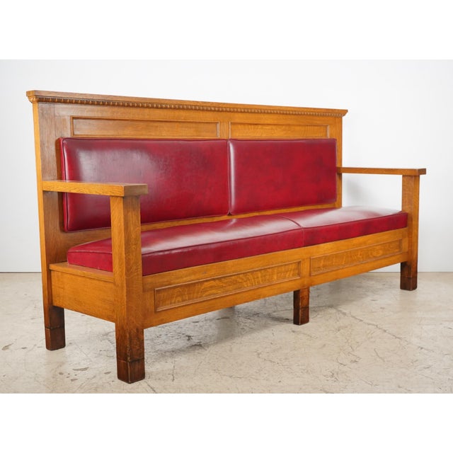 Mission style solid oak high back bench with egg & dart detail. The cushions are likely red naugahyde vinyl with no tears....