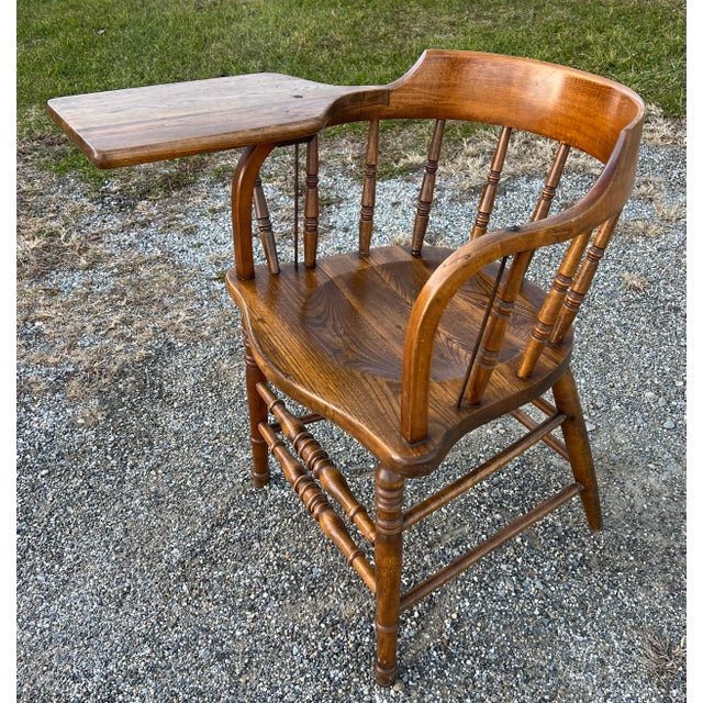 Vintage oak and chestnut barrel back firehouse or pub Windsor. This example has the rare addition of a writing arm. Nicely...