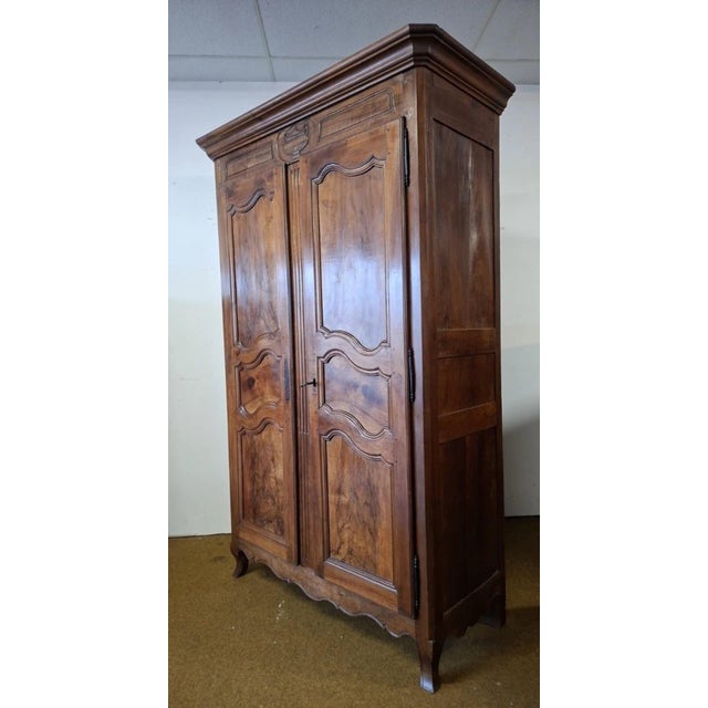 Louis xv period wardrobe in solid walnut, regional work from the rhône valley elegant solid wood wardrobe, opening with...