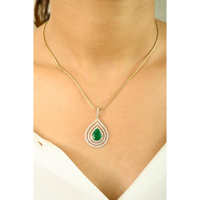 Elevate your elegance with this exquisite emerald pendant, crafted in luxurious 18k yellow gold. Featuring a captivating...