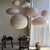 Large oval pendant light in a flattened pinkish-brown Japanese style, crafted from rattan and natural linen. Beautifully...
