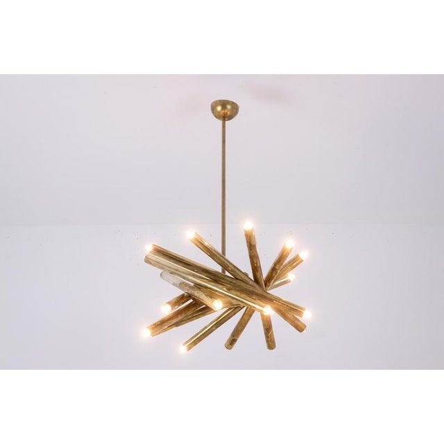 Pair of cylindrical shaped radiant tube chandelier in golden patinated brass. Italian work from the 70s. This piece is...
