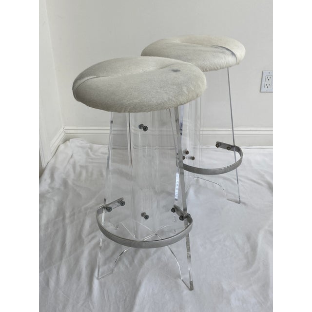 Mid-century modern lucite and cowhide bar stools