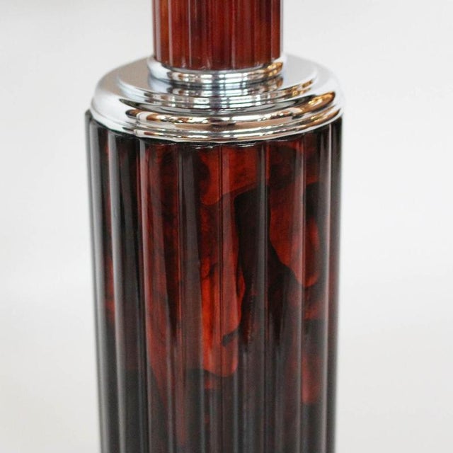 An art deco table lamp with domed shade. Reeded, deep, marbled burgundy, sectioned bakelite stem with chromed metal....