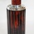 An art deco table lamp with domed shade. Reeded, deep, marbled burgundy, sectioned bakelite stem with chromed metal....