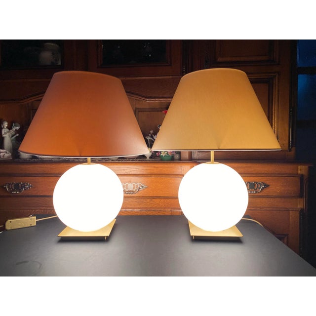 A pair of very elegant table lamps from famous German manufacturer Holtkötter. The spherical body is made of opal glass on...