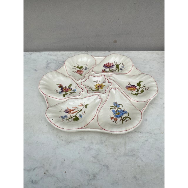 Majolica oyster plate with different flowers on each shells, circa 1900 signed Longchamp.