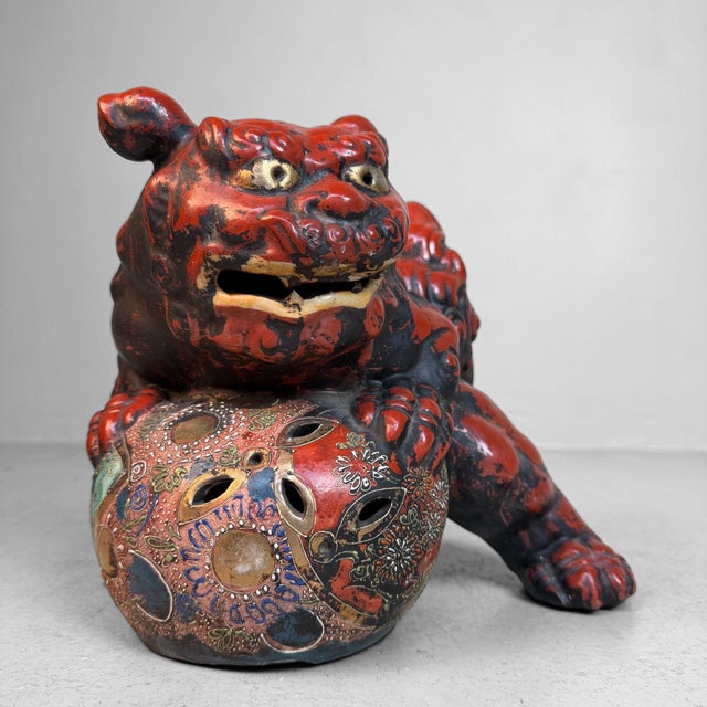 Decorative, expressive shishi (also known as komainu or lion-dog) from Japan, in a red and black finish with a richly...