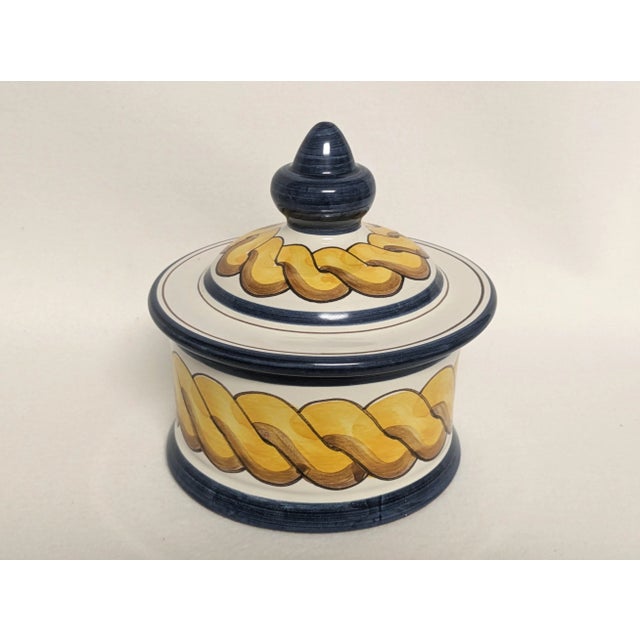 A hand-painted Spanish Triana lidded dish made in Seville Spain. The beautifully crafted ceramic bowl uses deep blue and...