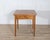 This square walnut table features a geometric inlaid top composed of bookmatched and angled walnut veneers that create a...