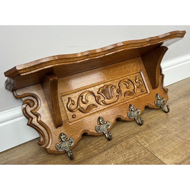 A charming Vintage French coat hanger, beautifully crafted with elegant carved detailing and a practical wall-mounted...