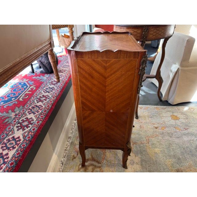 This is a French Louis XV style antique book table. It has one drawer and two shelves. It has a fabulous faux leather book...