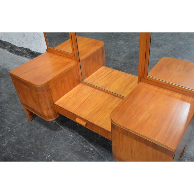 Unique Art Deco dressing table with foldable mirrors. Ample storage on the sides and pull-out drawer in the center.