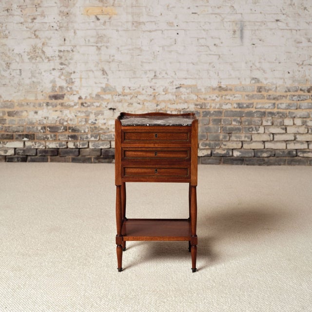 Add refined neoclassical elegance to your space with this 18th century French Louis XVI mahogany bedside table, a...