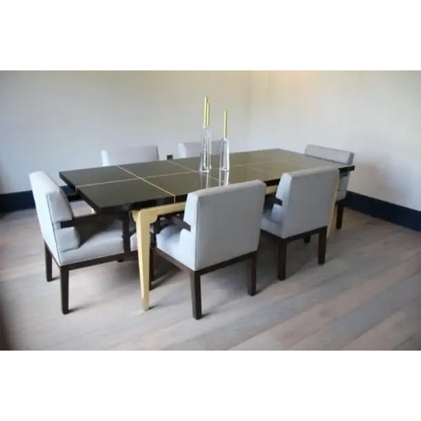 Sleek No. 161 dining table by Tommi Parzinger for Parzinger Originals featuring an inlaid dark mahogany lacquered top...