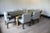 Sleek No. 161 dining table by Tommi Parzinger for Parzinger Originals featuring an inlaid dark mahogany lacquered top...