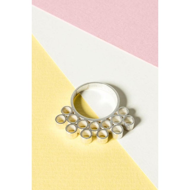 Amazing silver ring by Cecilia Johansson with a frill of bubbly circles stacked on top. An imaginative design made with...