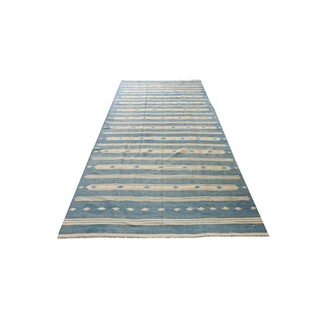 This vintage 5×11 Dhurrie is an exciting new entry in Rug & Kilim’s esteemed flat weave collection. Handwoven in cotton,...