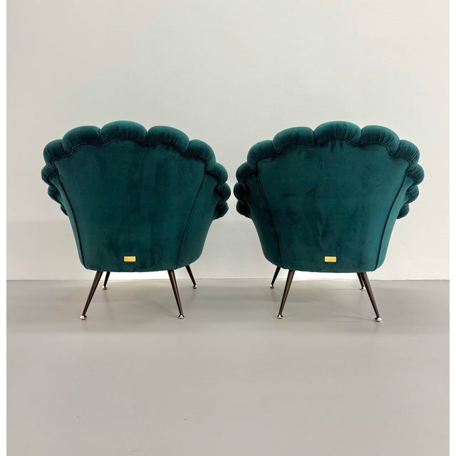 Striking Gucci shell-back armchairs upholstered in rich teal velvet with embroidered floral seat detailing. Their...