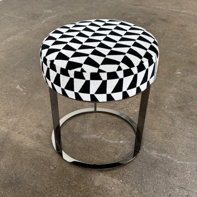 The Frank Ottoman with high round cushion offers a small additional seating element. Upholstered in a graphic black and...