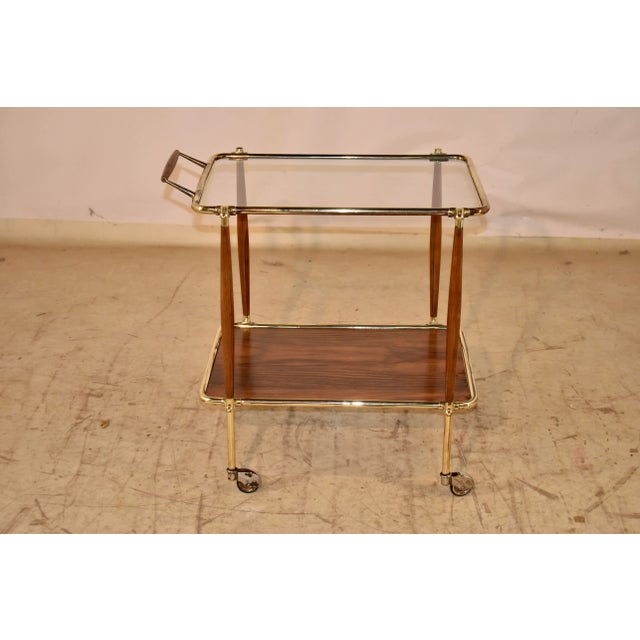 Mid-century modern bar cart made from brass, glass and walnut. This is an absolutely stunning bar cart which is elegant in...